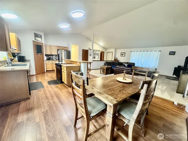 a kitchen with a table chairs stove and cabinets