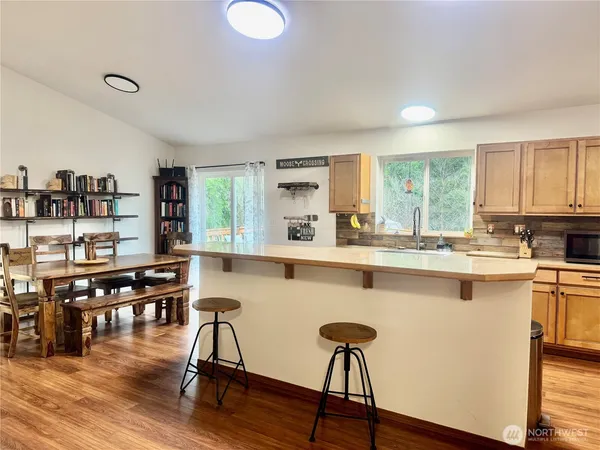 a view of a dining room with furniture and a wooden floor