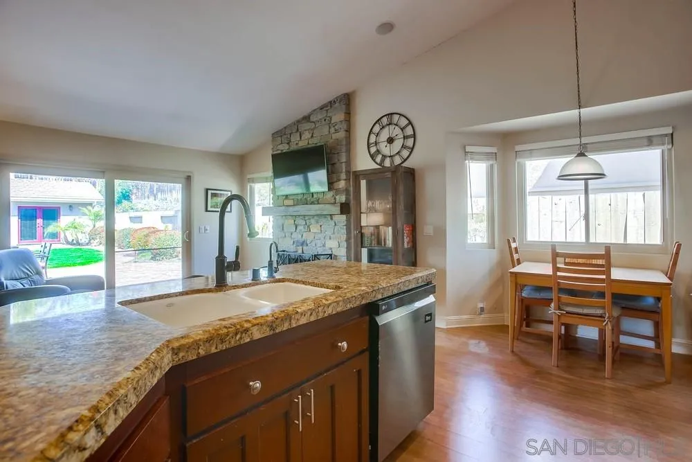 13036 Treecrest Street Poway, CA 92064 - Photo 12 of 37 a view of a kitchen and dining area with chandelier
