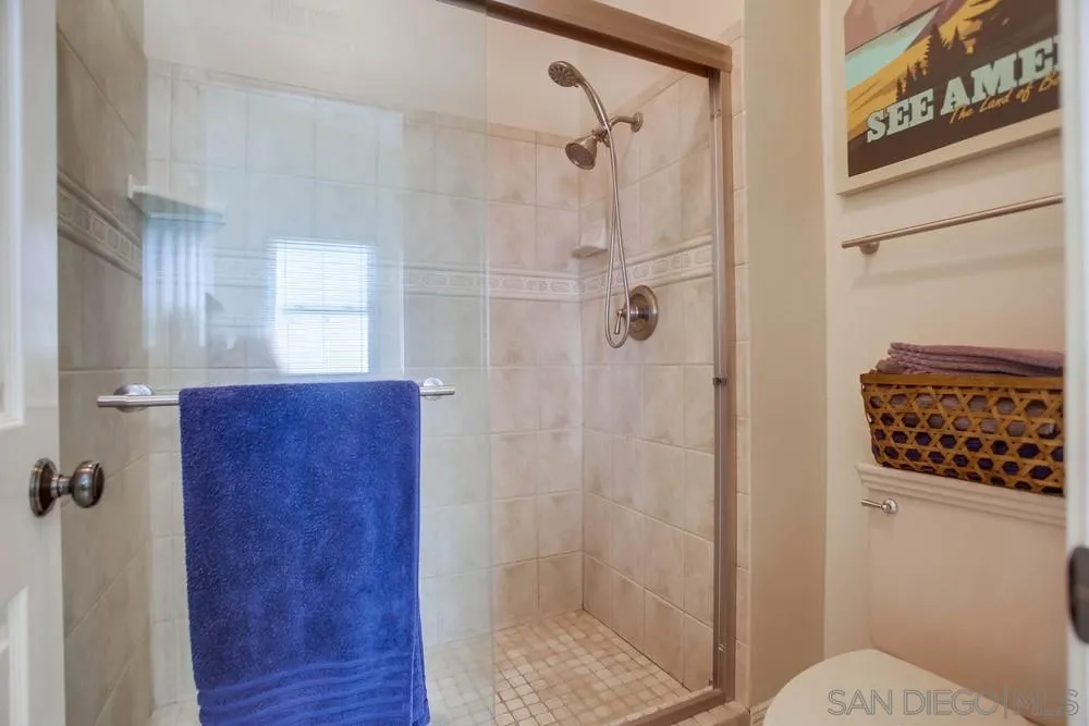 13036 Treecrest Street Poway, CA 92064 - Photo 16 of 37 a bathroom with a shower a toilet and a sink
