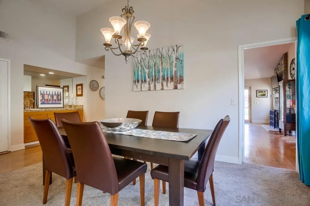 13036 Treecrest Street Poway, CA 92064 - Photo 4 of 37 a view of a dining room with furniture and chandelier