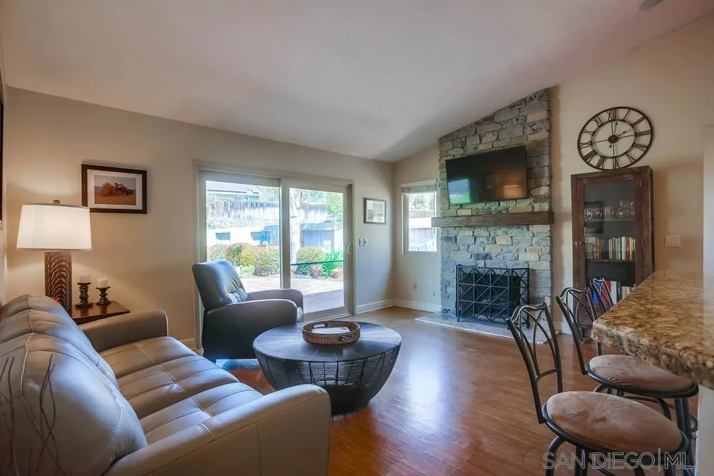 13036 Treecrest Street Poway, CA 92064 - Photo 6 of 37 a living room with furniture a fireplace and a flat screen tv