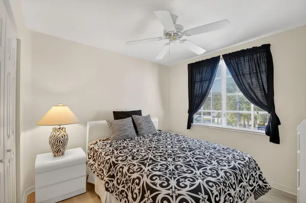 a bedroom with a bed and a lamp