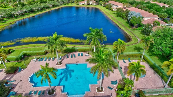 an aerial view of residential houses with outdoor space and swimming pool
