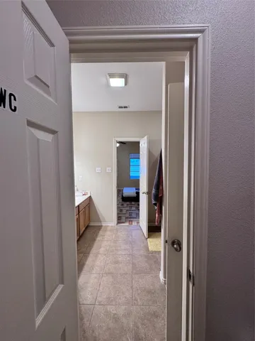 a view of a hallway view with wooden floor and staircase