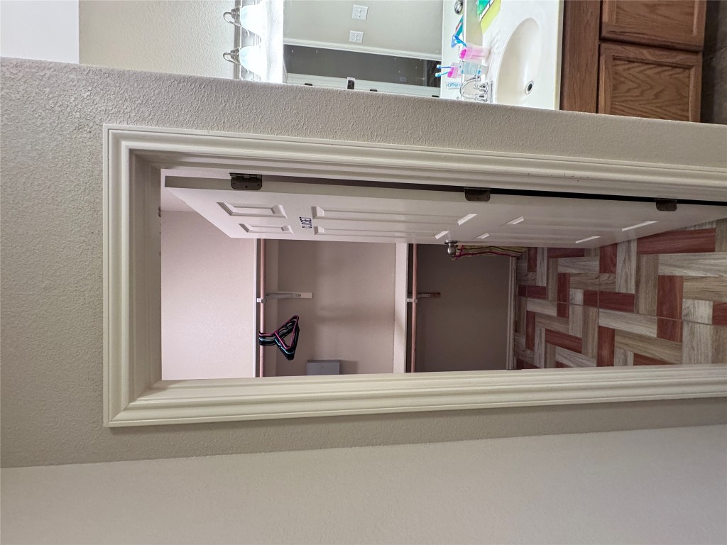 11202 Granados Street Laredo, TX 78045 - Photo 12 of 17 a bathroom with a walk in closet and wooden floor