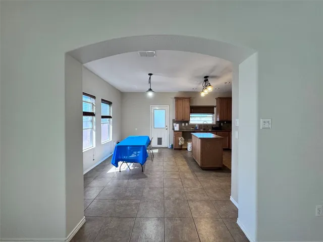 a living room with furniture and kitchen view