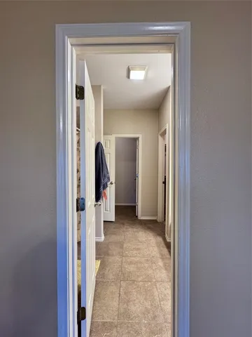 a view of a hallway with wooden shelves