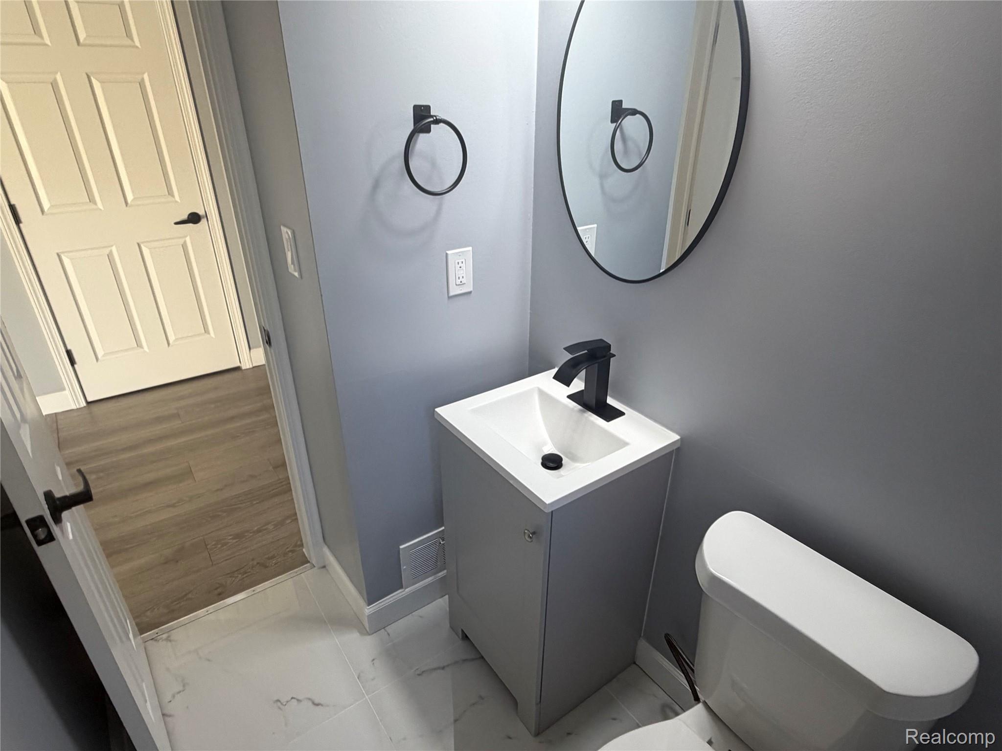 20698 Coachwood Road Riverview, MI 48193 - Photo 10 of 37 Half bath featuring light marble finish floors and vanity