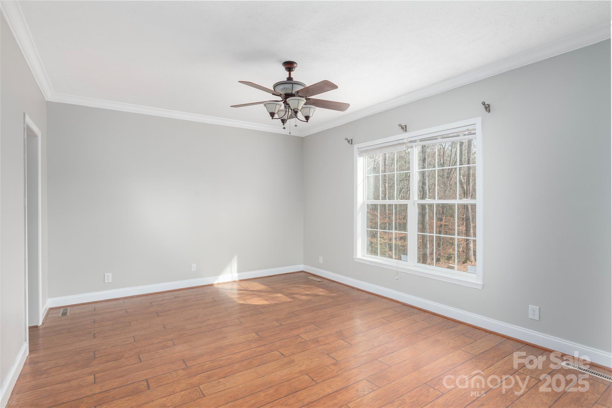 236 Pole Miller Extension Brevard, NC 28712 - Photo 12 of 38 a view of empty room with wooden floor and fan