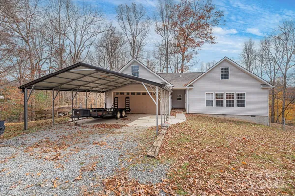 a front view of a house with a yard and seating space