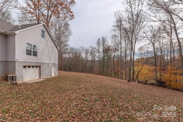 a backyard of a house with large trees