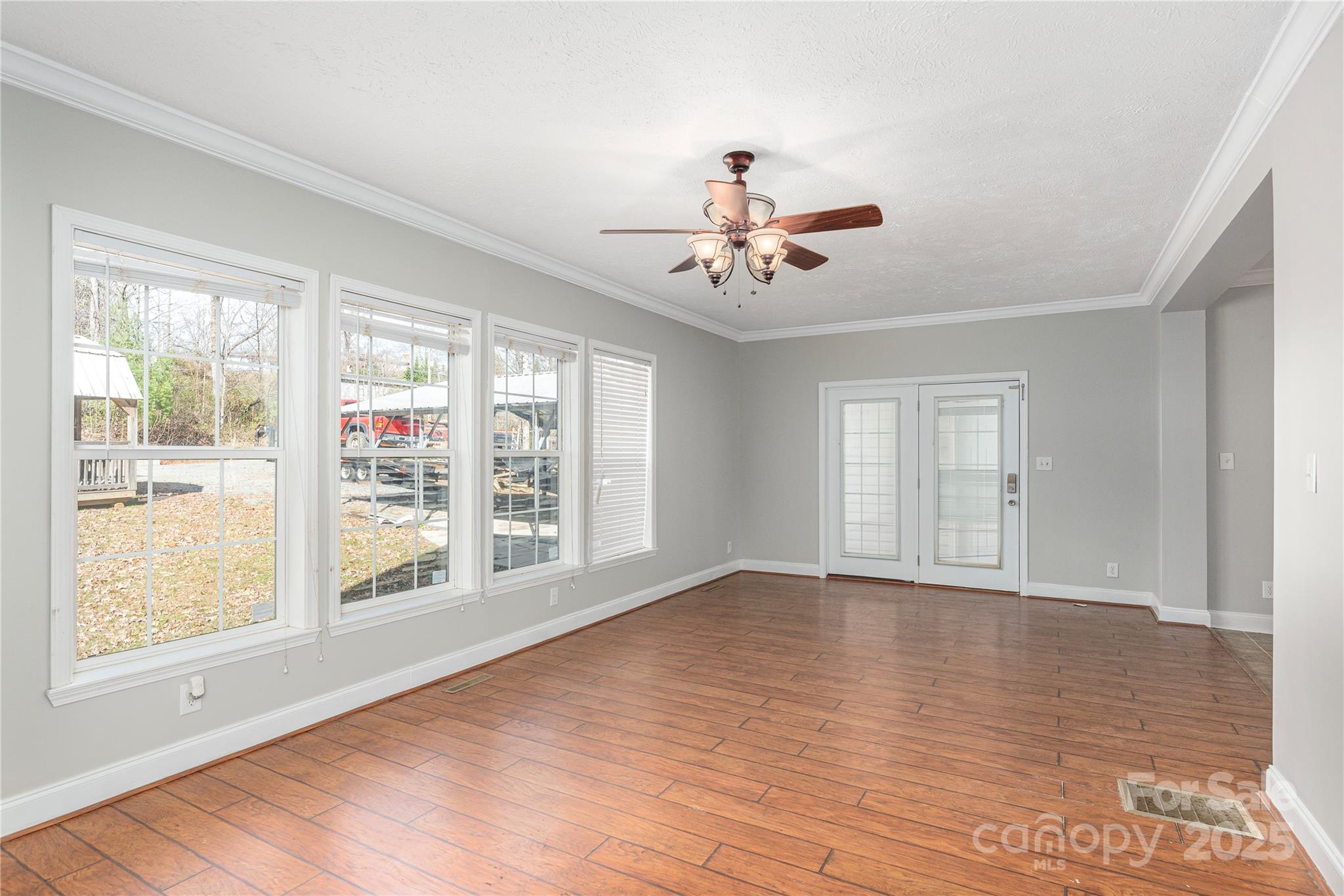 236 Pole Miller Extension Brevard, NC 28712 - Photo 6 of 38 a view of an empty room with a window and wooden floor