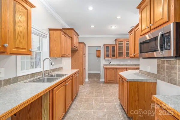 a kitchen with stainless steel appliances granite countertop wooden cabinets a sink and a granite counter tops