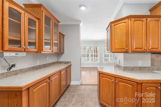 a kitchen with stainless steel appliances granite countertop a sink and dishwasher next to a window
