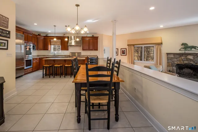 a living room with furniture a dining table and kitchen view