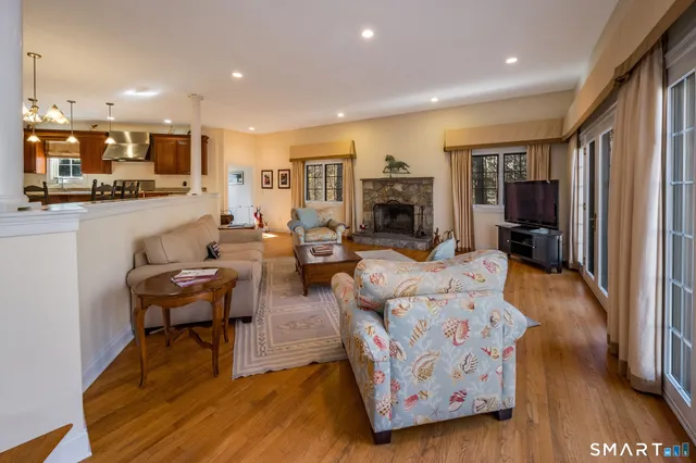 a living room with fireplace furniture and a flat screen tv