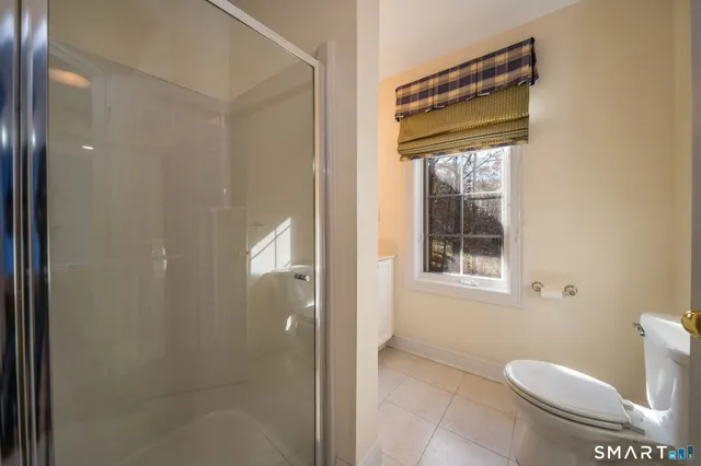a bathroom with a toilet and a shower