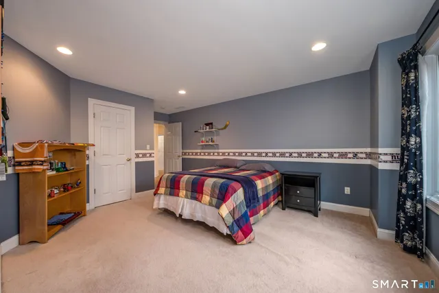 a bedroom with a bed and a couch