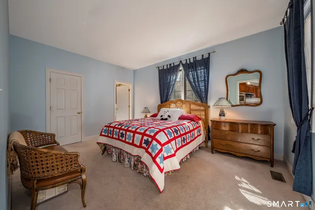 a bedroom with a bed and a couch