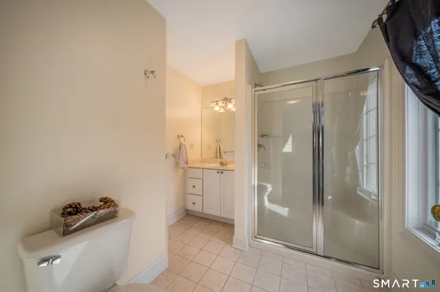 a bathroom with a tub shower and sink