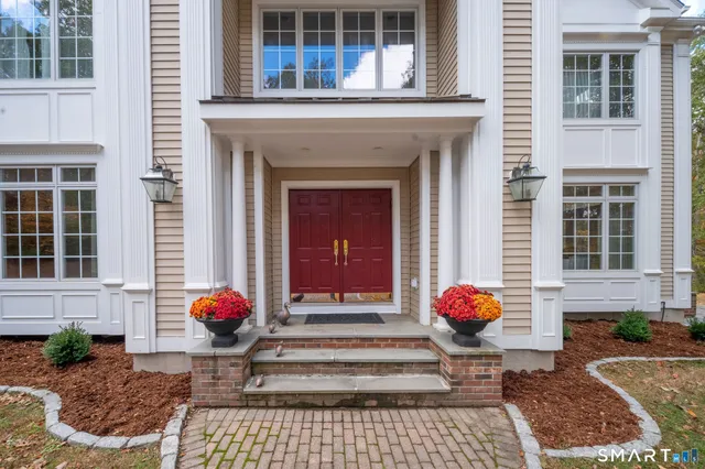 a front view of a house with a garden