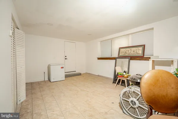 a view of a room with table and chairs
