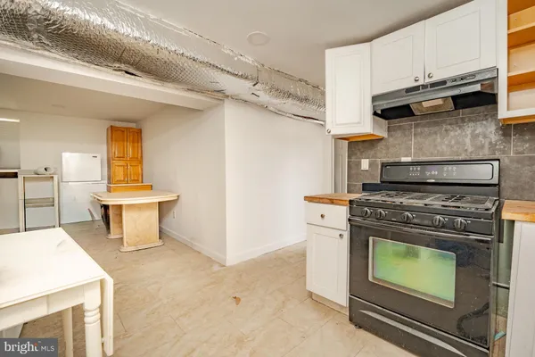 a kitchen with a stove and a refrigerator