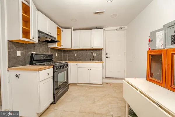 a kitchen with a white cabinets and white appliances