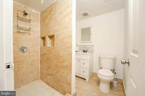 a bathroom with a toilet and a shower