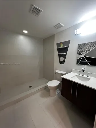 a bathroom with a toilet sink double vanity and mirror