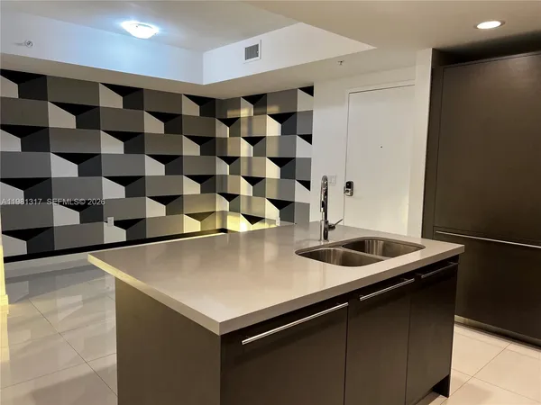 a kitchen with a sink and a refrigerator