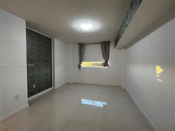 an empty room with windows and entrance