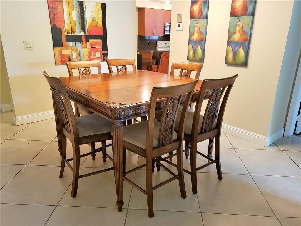 16325 Golf Club Road, Unit 112 Weston, FL 33326 - Photo 11 of 26 a dining room with furniture and wooden floor