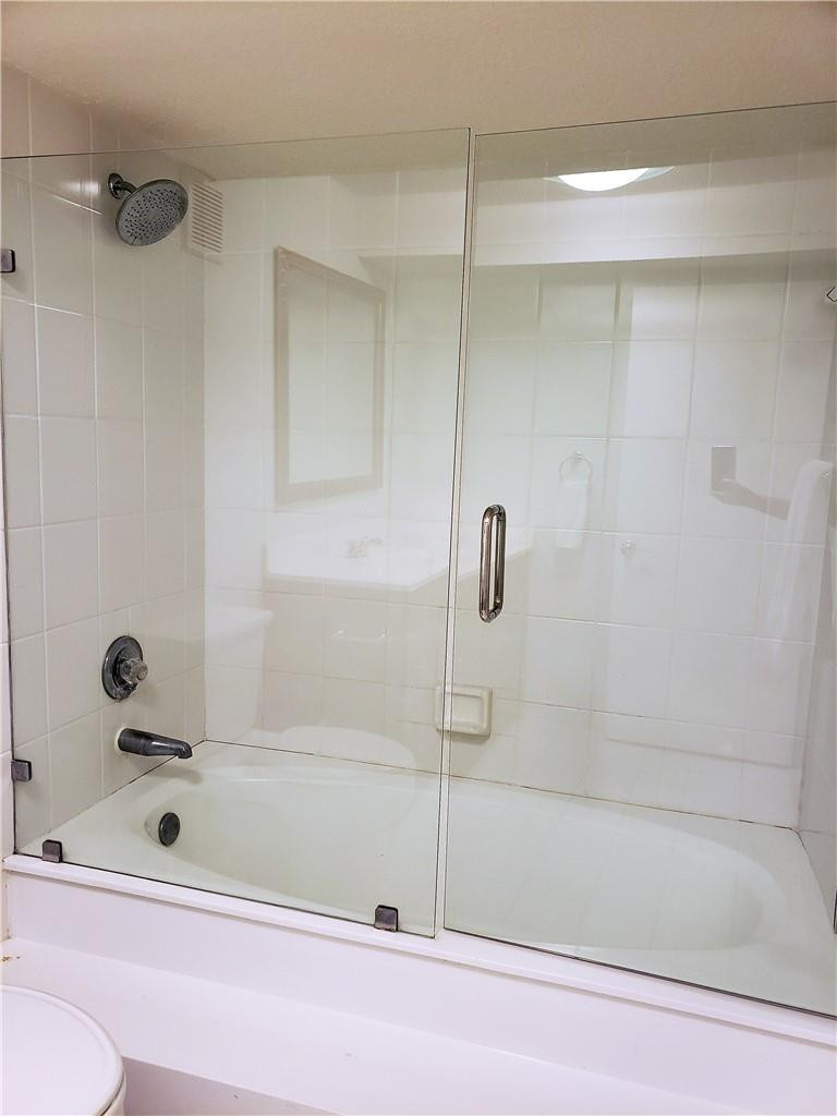 16325 Golf Club Road, Unit 112 Weston, FL 33326 - Photo 13 of 26 a bathroom with a bathtub and a shower