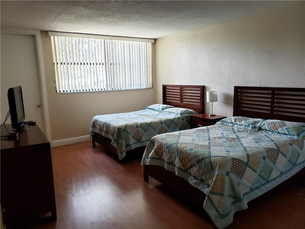16325 Golf Club Road, Unit 112 Weston, FL 33326 - Photo 14 of 26 a bedroom with two beds and a window