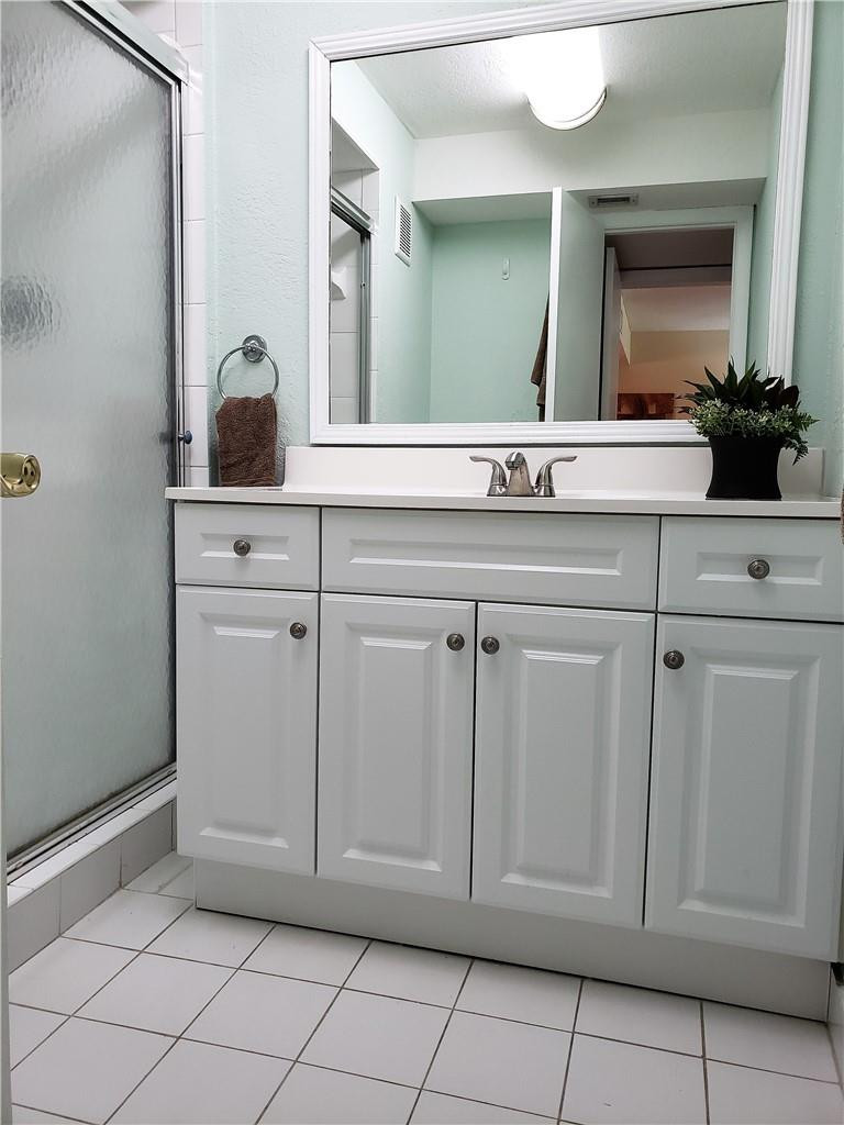 16325 Golf Club Road, Unit 112 Weston, FL 33326 - Photo 15 of 26 a bathroom with a sink and a mirror