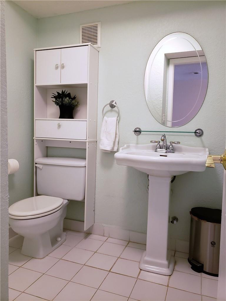 16325 Golf Club Road, Unit 112 Weston, FL 33326 - Photo 19 of 26 a bathroom with a sink toilet and mirror