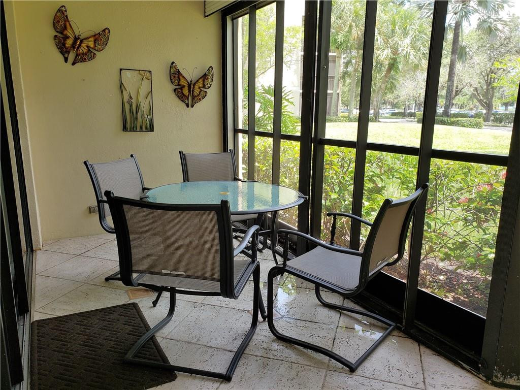 16325 Golf Club Road, Unit 112 Weston, FL 33326 - Photo 20 of 26 a dining room with furniture and a window