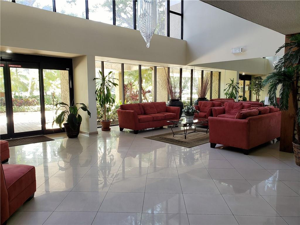 16325 Golf Club Road, Unit 112 Weston, FL 33326 - Photo 22 of 26 a living room with furniture and large windows
