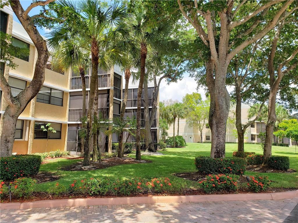16325 Golf Club Road, Unit 112 Weston, FL 33326 - Photo 24 of 26 a view of a building with a yard
