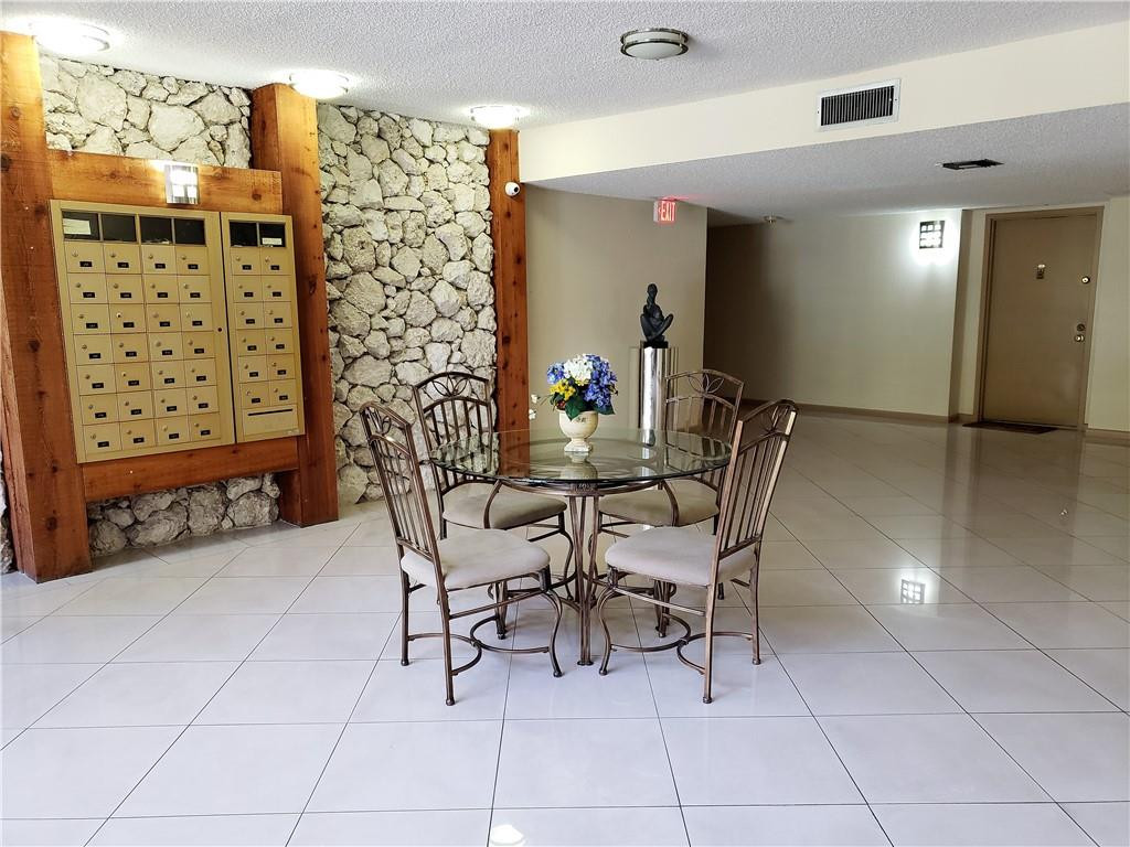 16325 Golf Club Road, Unit 112 Weston, FL 33326 - Photo 26 of 26 a dining room with furniture and a chandelier