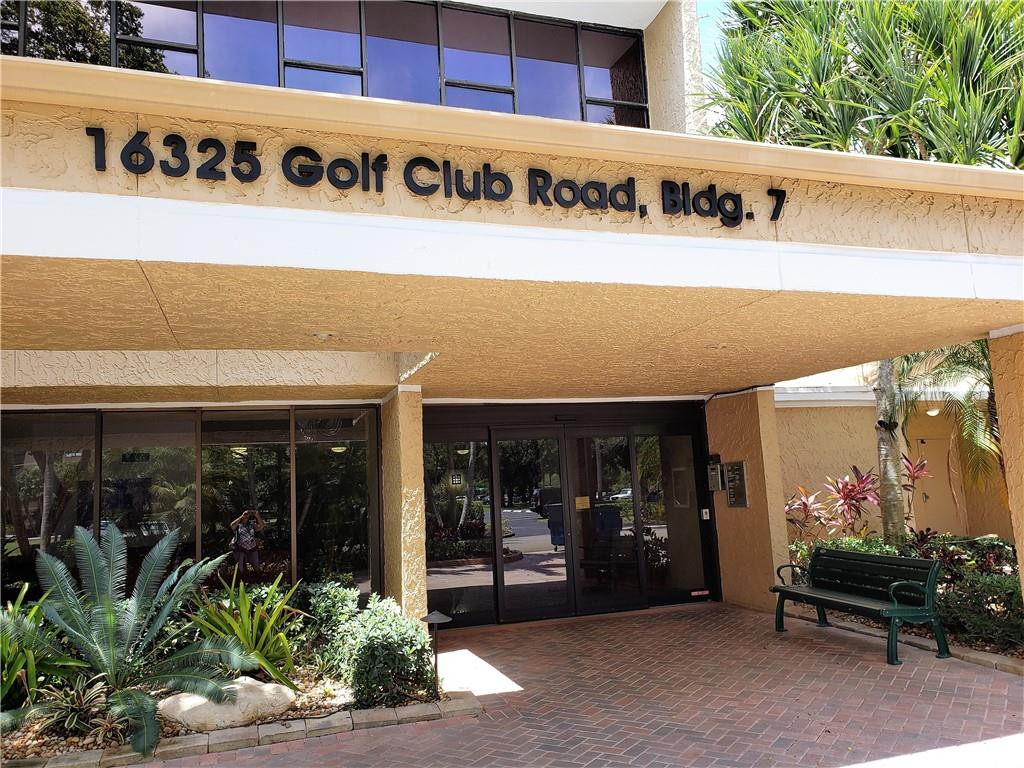 16325 Golf Club Road, Unit 112 Weston, FL 33326 - Photo 4 of 26 a front view of a building with retail shop and outdoor seating