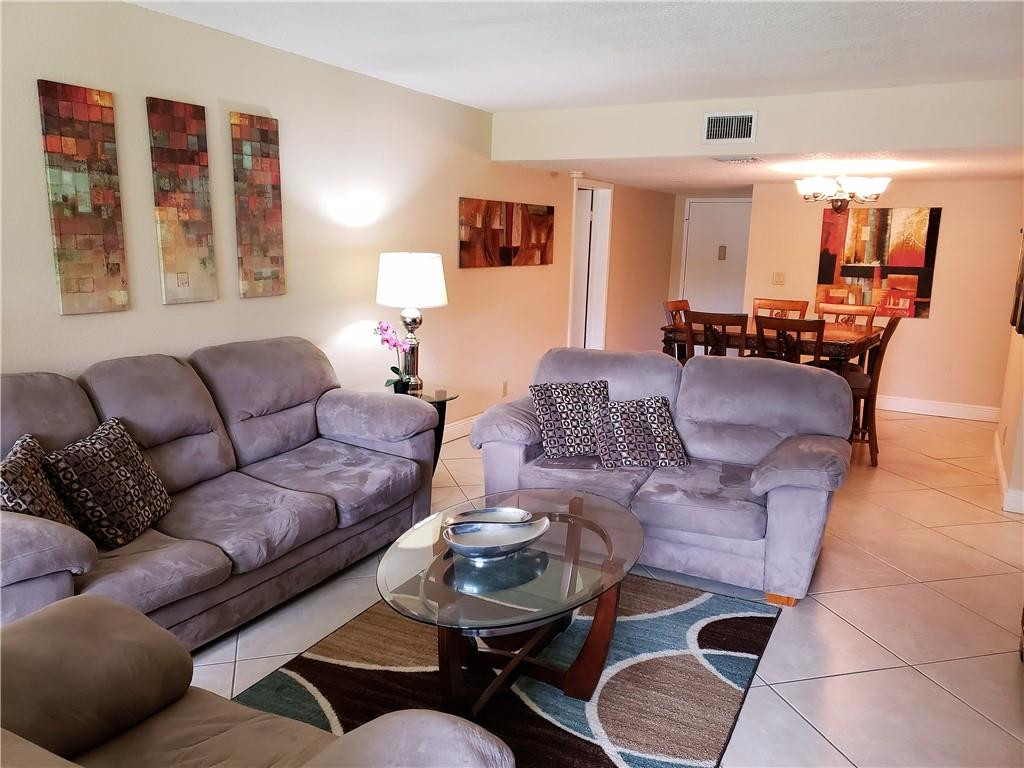 16325 Golf Club Road, Unit 112 Weston, FL 33326 - Photo 5 of 26 a living room with furniture and wooden floor