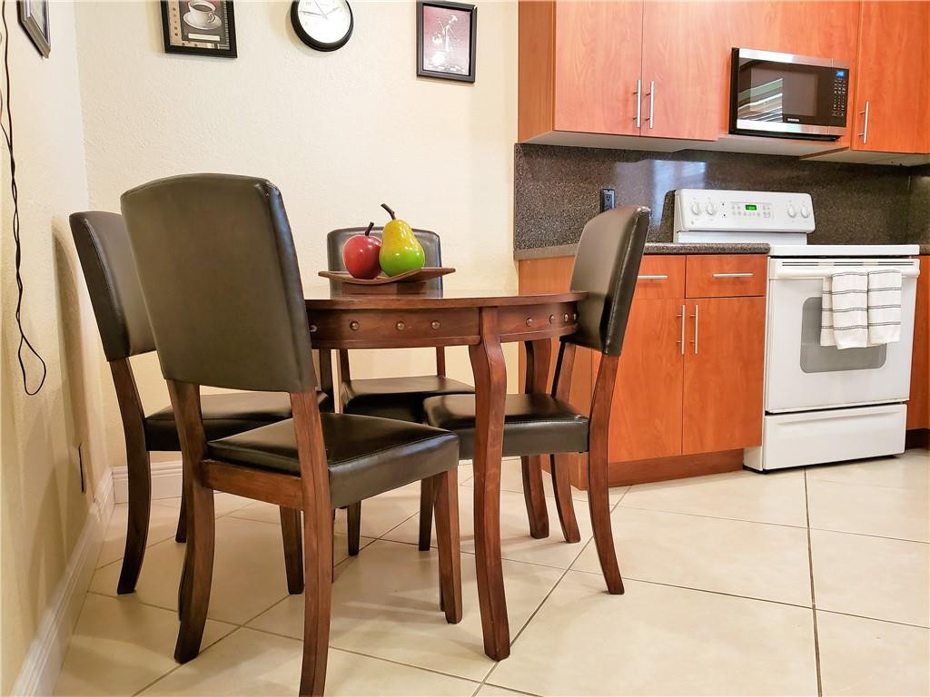 16325 Golf Club Road, Unit 112 Weston, FL 33326 - Photo 7 of 26 a dining room with furniture and window