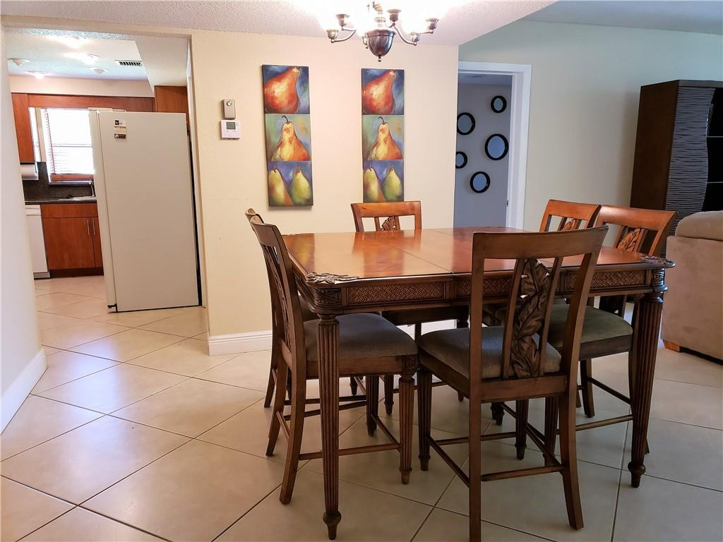 16325 Golf Club Road, Unit 112 Weston, FL 33326 - Photo 9 of 26 a view of a dining room with furniture