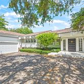 a view of a house with backyard and a tree
