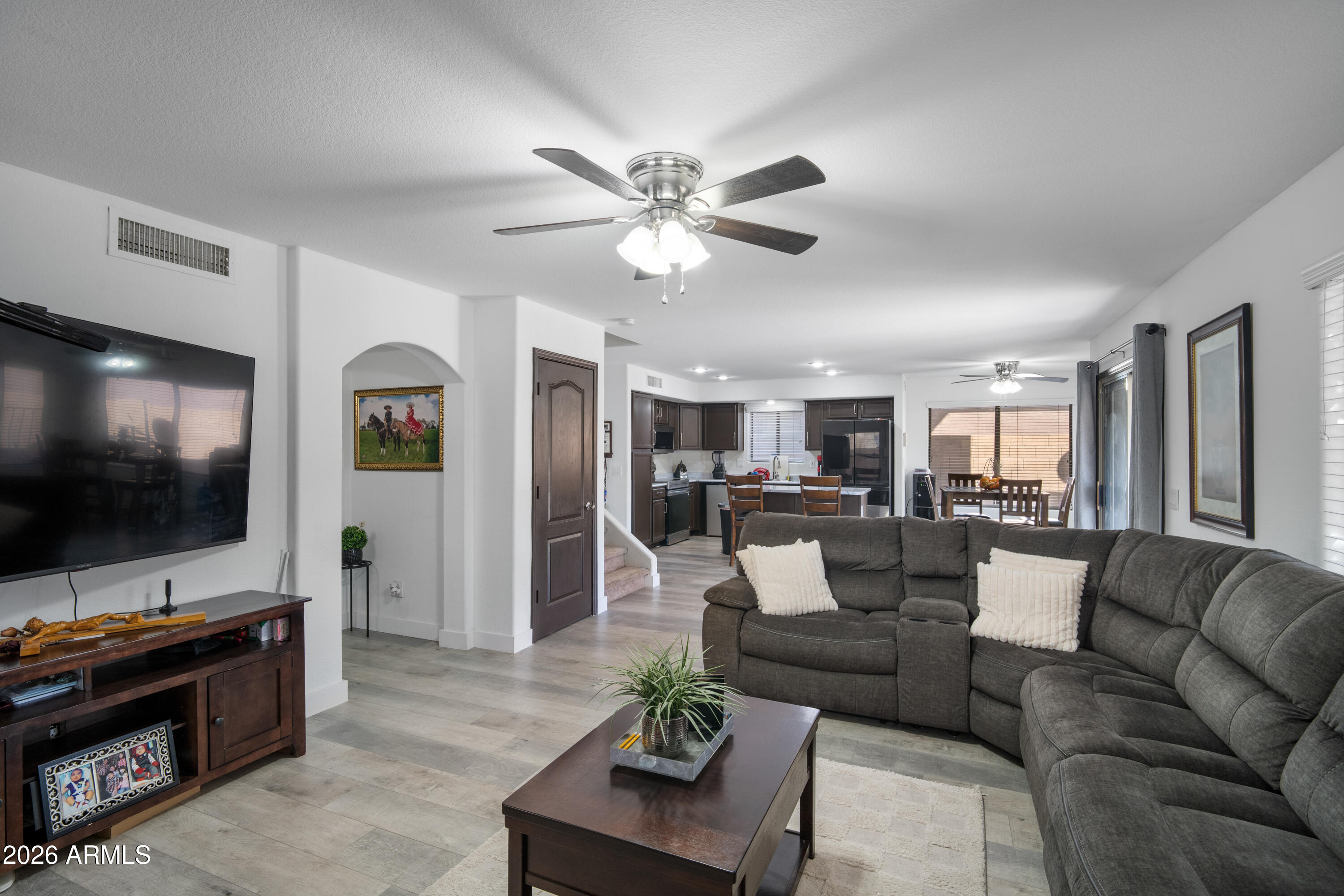 16221 West Latham Street Goodyear, AZ 85338 - Photo 12 of 30 a living room with furniture and a flat screen tv