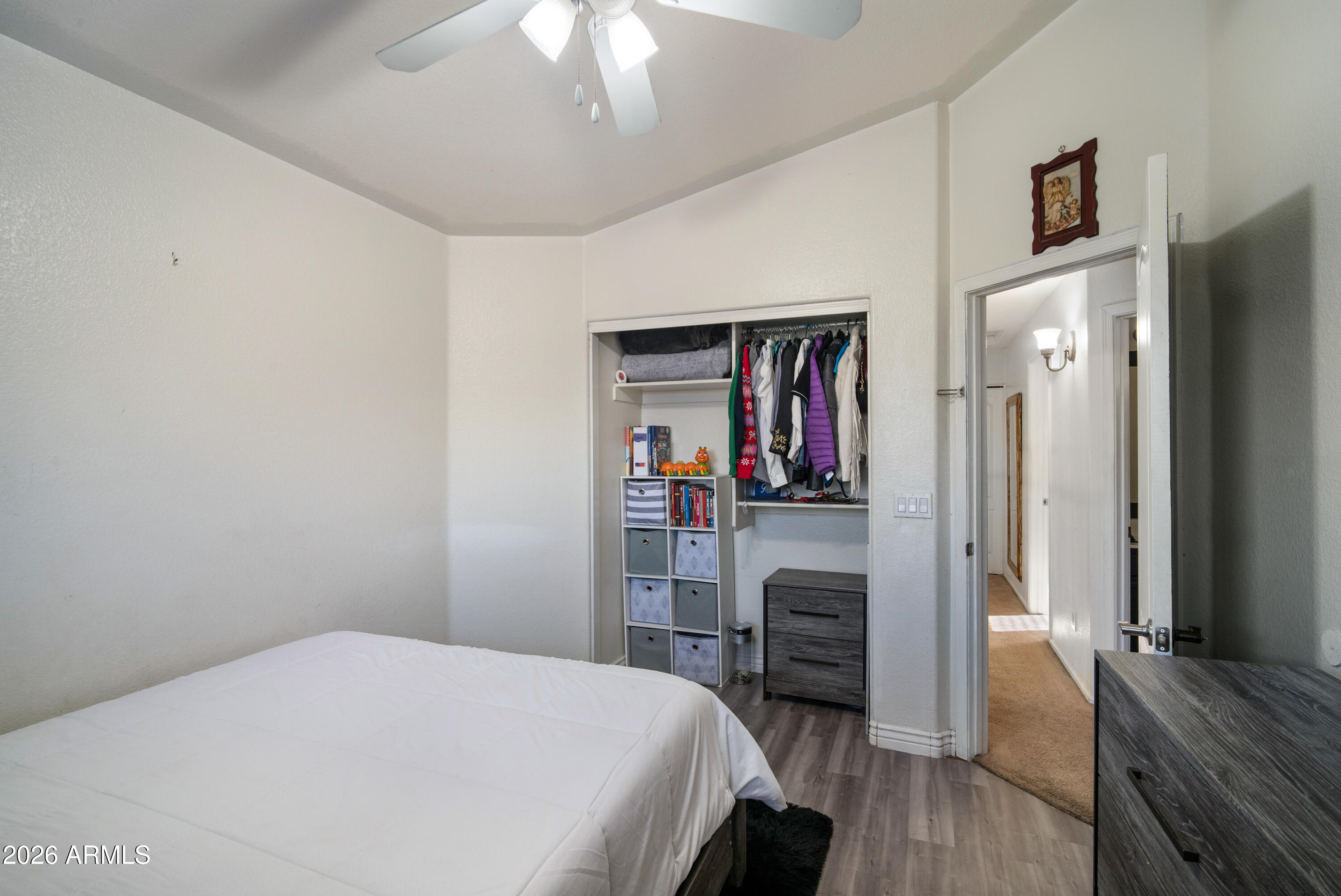 16221 West Latham Street Goodyear, AZ 85338 - Photo 18 of 30 a bedroom with a bed and a flat screen tv