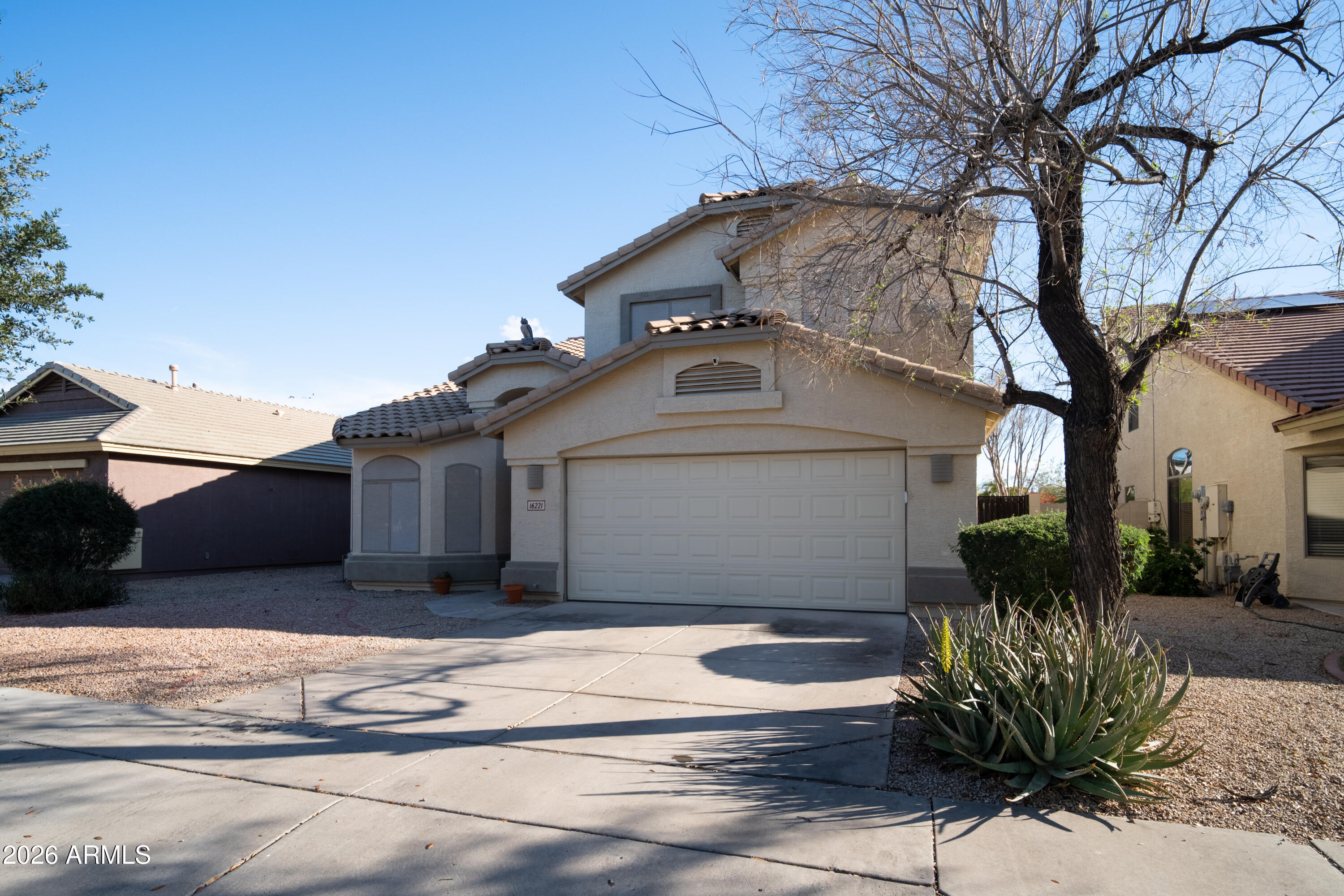 16221 West Latham Street Goodyear, AZ 85338 - Photo 2 of 30 a front view of a house with a yard